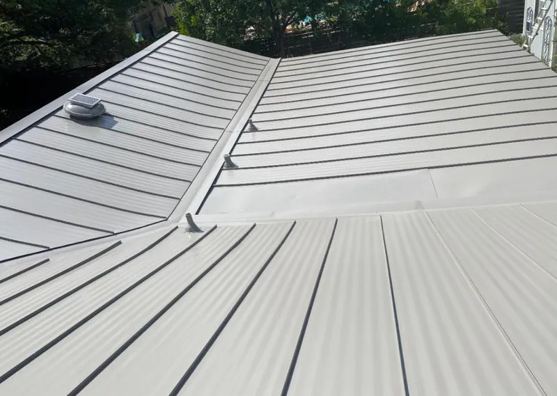 Solar attic fan installed on a metal roof for Roof Ventilation in Manitowoc